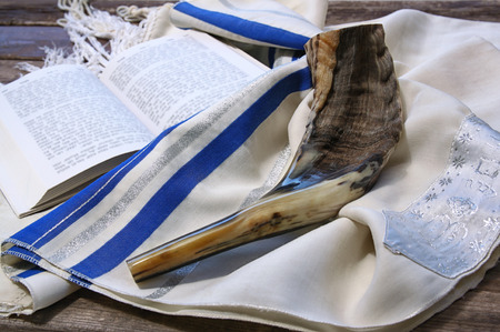 42637486 - shofar horn on white prayer talit. room for text. rosh hashanah jewish holiday concept . traditional holiday symbol.