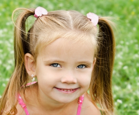 21090108 - cute smiling little girl on the meadow in summer day